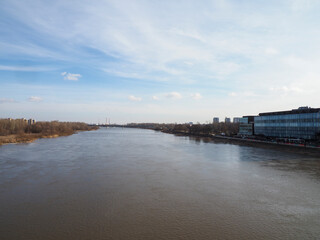Fototapeta premium View of the wide Vistula river under a bright cloudy sky in Warsaw