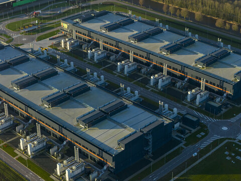 Aerial view of large server farms hosting information technology infrastructure and cloud computing ai services. Modern facility for digital data storage, Middenmeer, Netherlands.