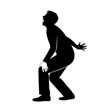 Man bending down in pain silhouette.