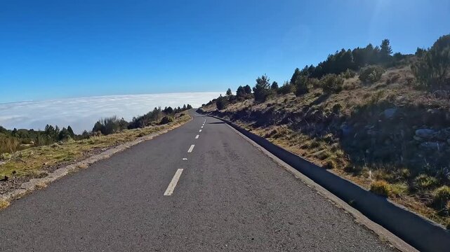 Portugal, Madeira, Funchal, Caminho Florestal das Serras de Santo Ant&oacute;nio. This hyperlapse footage captures a dynamic drive along a high-altitude mountain road,  above a sea of white clouds.