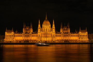 Budapest Parliament illuminated at night reflected in river © Sergey