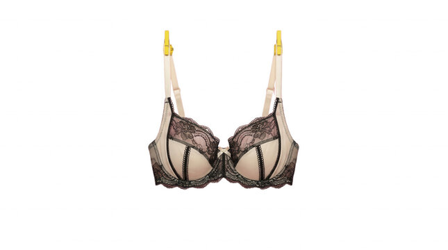 Elegant lace bra hanging on clothespins against black background represents delicate lingerie and intimate apparel fashion