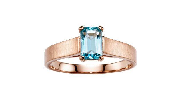 Isolated elegant rose gold ring featuring a sparkling emerald cut blue gemstone in prongs