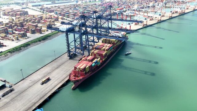 Stunning Aerial view of container ship at Port of Tanjung Pelepas Johor Malaysia. maritime operations, featuring giant gantry cranes and vast container yards