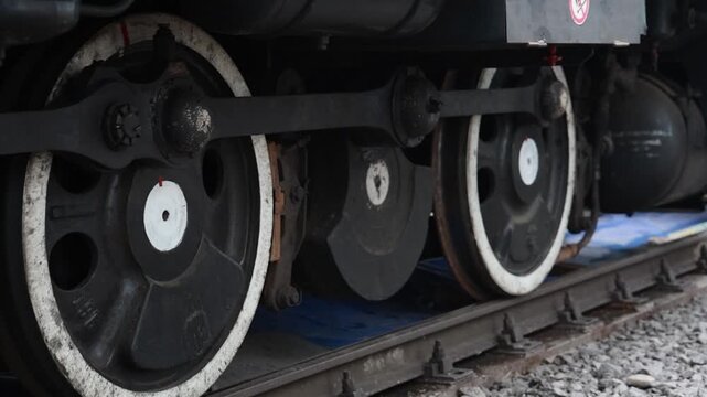 Close-Up of Train Wheels Moving Slowly on Railway Tracks