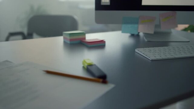 Modern office desk featuring a laptop, colorful stationery supplies, and a notebook arranged neatly on a wooden table for business and education