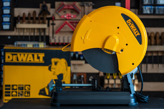DeWalt D28730 metal cut off saw on workbench in workshop environment with tools in background representing professional construction metal cutting and industrial equipment