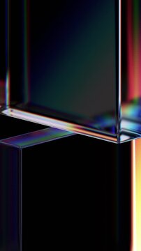 Abstract iridescent glass shapes on a black background, vertical 4k seamless loop 3d animation