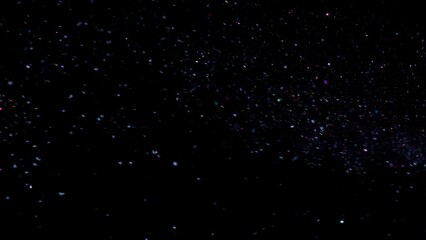Obraz premium Freeze Motion Shot of Color Glitter Background Isolated on Black