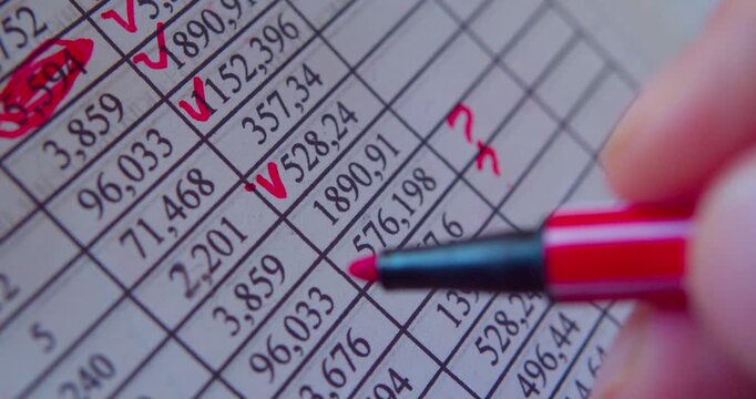 Paper work.Business concept illustrated by close-up footage of a marker working with numerals on paper.