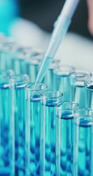 Scientist, pipette and liquid in test tubes in lab for enzyme analysis, biological staining or innovation. Science, person and vial samples in containers for cell culture, medical research or closeup