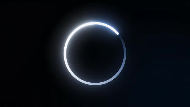 A bright white ring emits a soft glow against a dark background