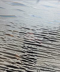 Adhesive film worn and cracked by the sun. Abstract shapes background .