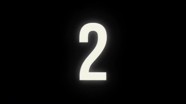 Glowing number two against a dark, black background with soft illumination