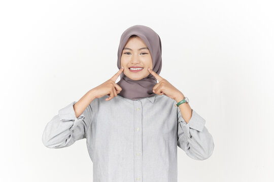 Playful Young Hijabi Woman Pointing Fingers at Her Cheeks and Dimples