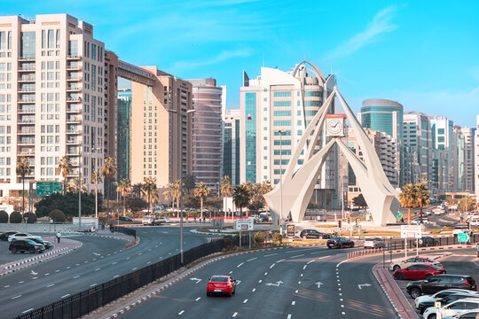 10 January 2026, Dubai, UAE: Deira Clocktower landmark with traffic navigating the urban roundabout surrounded by contemporary architecture and palm trees