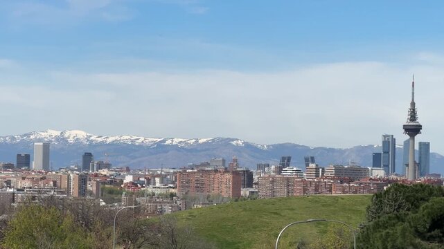 Madrid skyline with snowy mountains from tio pio park