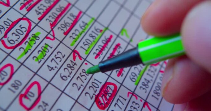 Paperwork.Close-up video of marker working with numbers on a paper sheet, illustrating business concept.