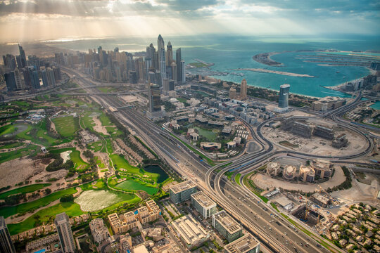 Dynamic aerial tour showcases supertall skyscrapers, and futuristic cityscape blending golden sands with glittering waterways.