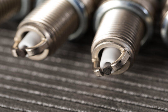 Automotive spark plugs detail close up, essential engine component for combustion, vehicle maintenance, ignition system part, car technology