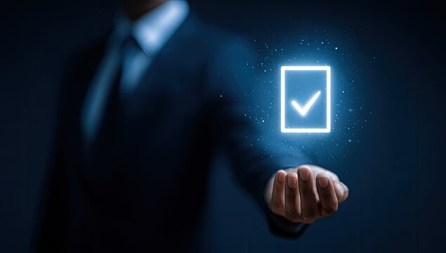 Businessman holding a glowing checkmark symbol of success, accuracy, and completion