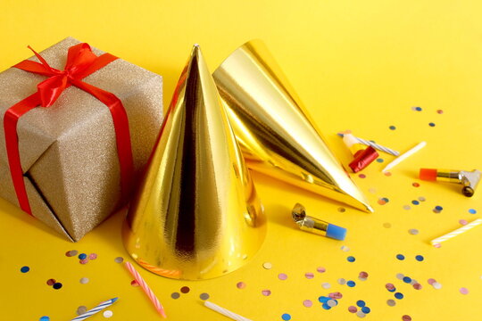 Birthday party items are on a yellow background.