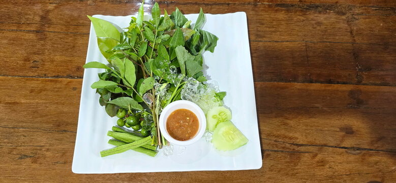 Southern-style shrimp paste chili dip or Southern Thai chili paste, served with side vegetables or fresh herbs and vegetables such as Centella , Knotgrass, Cashew sprouts, green beans, cucumbers, ice
