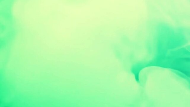 Dense, emerald-colored plumes of smoke drift across the frame in a slow, rhythmic motion. This abstract visual offers a moody, cinematic atmosphere with high-contrast textures and organic depth.