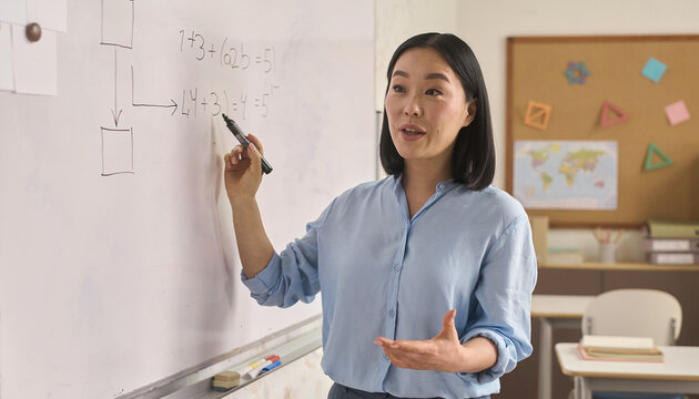 Candid documentary of a diverse Asian teacher explaining math on a whiteboard in natural light, showing an authentic real life morning routine and education balance for a modern family story