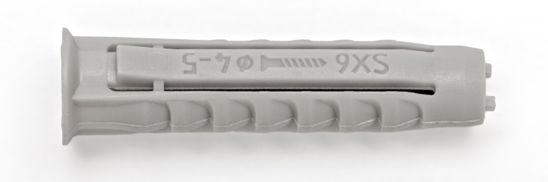 Grey nylon SX6 wall plug macro on white background