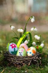 cute self created easter eggs in a nest in the garden
