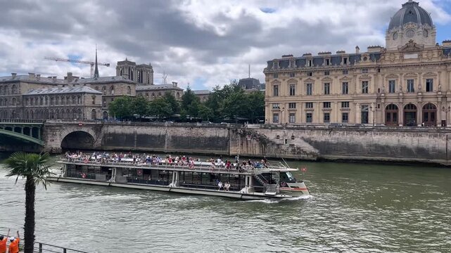 PARIS, FRANCE &ndash; August, 14, 2024: River Seine in Paris capital of France, sightseeing boat for tourists on sunny day sailing along the river between the banks with famous tourist attractions