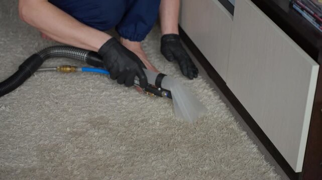 Precise Edge And Corner Cleaning. Specialist Uses Small Tools To Thoroughly Clean Carpet Edges. Meticulous Cleaner Employs Precise Techniques To Remove Dirt From Carpet Borders And Corners