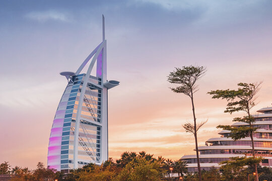 10 January 2026, Dubai, UAE: Burj Al Arab luxury hotel standing as a modern landmark at Jumeirah Beach, reflecting vibrant colors during golden hour