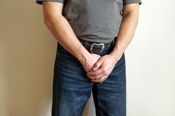 Senior man holding his crotch with prostate problems