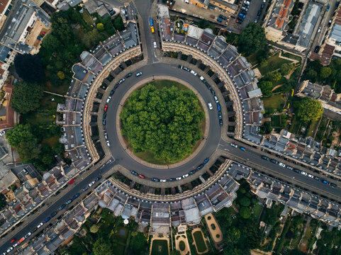 Aerial view of The Circus, a ring of Georgian townhouses, encircling a verdant green space, creates a mesmerizing geometric pattern from above, Bath, England, United Kingdom.