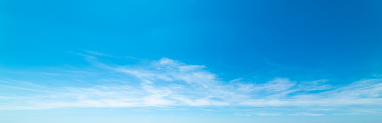 Fototapeta premium Blue sky with few small white soft clouds