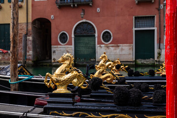 Close-up of Venetian gondola details, showcasing traditional craftsmanship and decorative elements in Venice, Italy. © Yuliya Ihnatkovich