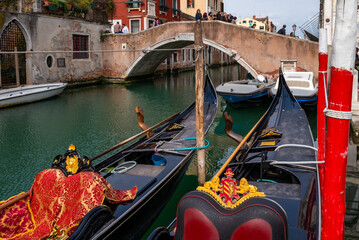 Close-up of gondola interior in Venice, Italy, showing traditional seating and decorative details  © Yuliya Ihnatkovich