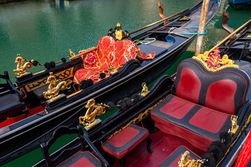 Close-up of gondola interior in Venice, Italy, showing traditional seating and decorative details  © Yuliya Ihnatkovich