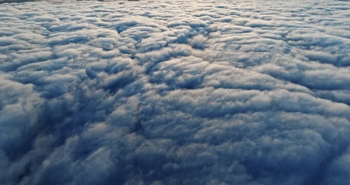 Top down aerial perspective dense cumulus clouds sunset. Drone shot atmospheric sky background majestic nature. Heavenly cloudscape freedom travel peace tranquility concept scene