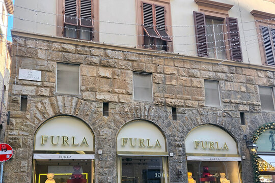 Florence, Italy, January 1, 2026: Historic Building Facade with Furla Storefront on Via Calzaiuoli in Florence, Italy