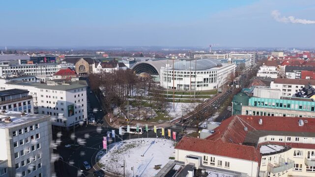 Urban landscape of Bielefeld Germany with Willy Brandt Platz roundabout traffic and modern architecture on a sunny winter day
