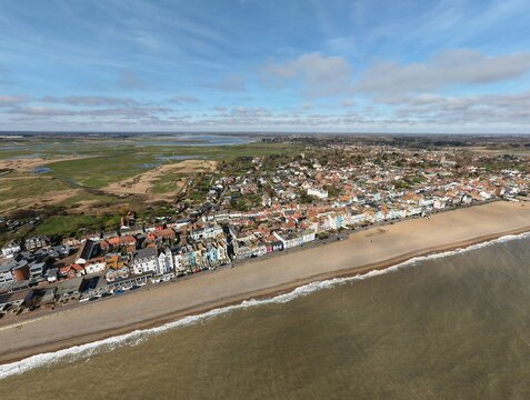 Aerial view of the beachside town of Aldeburgh under a vast sky, where the sea's edge meets the land in a gentle embrace, Aldeburgh, England, United Kingdom.