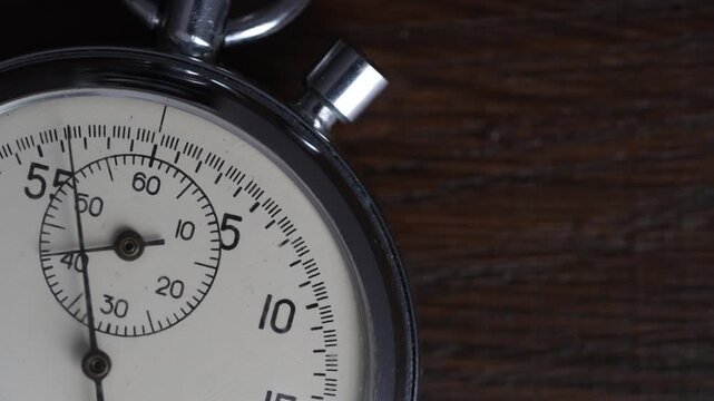Detail of antique mechanical pocket stopwatch in a metal chrome-plated case, close up