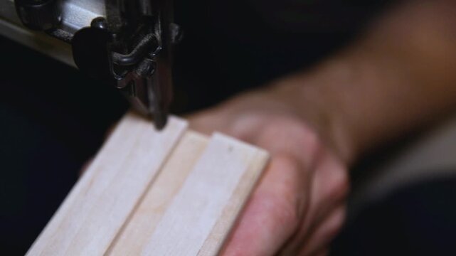 Pneumatic brad nailer securing to fasten the wooden planks, Nail gun drives fasteners smoothly, showing craftsmanship and professional home renovation work.