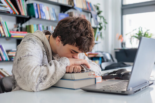 Exhausted teen student preparing for exams, burnout and mental health concept. 