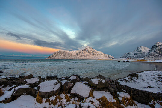 Winter beach landscape surrounded by snowy mountains, Brunstranda, Flakstad, Lofoten, Lofoten and Vesteral Islands, Norway