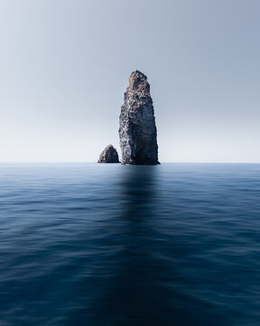 View of the volcanic sea stacks of the Aeolian Islands rising from the deep blue Mediterranean sea under a clear sky Sicily, Italy.