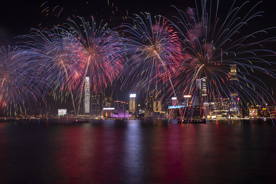View of colorful fireworks exploding over the illuminated skyline of Victoria Harbour at night Hong Kong, Hong Kong.